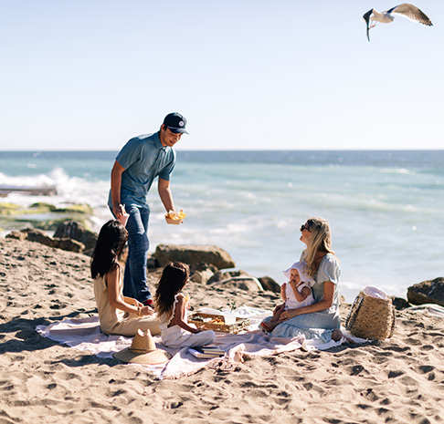 Group of people on the beach having lunch. 