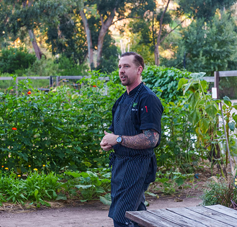 Kyle St. John Executive Chef in the garden.