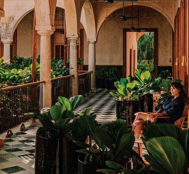 woman sitting with plants