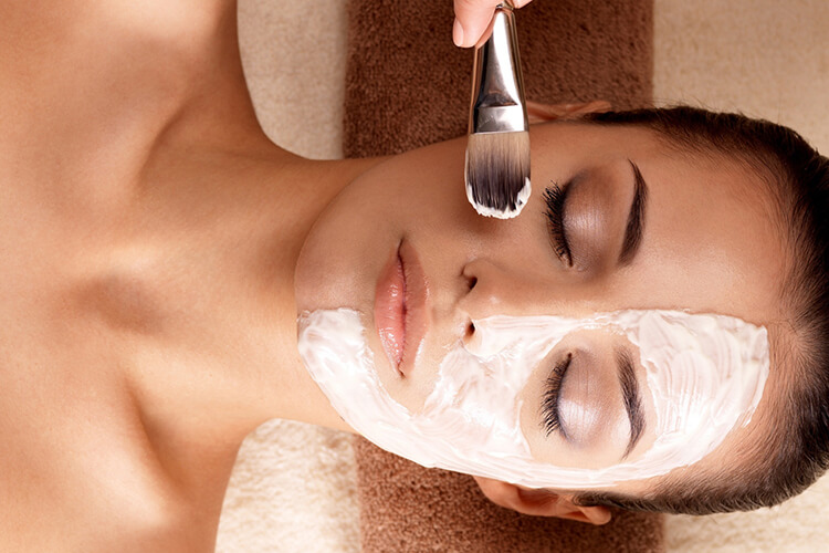 Guest at the spa receiving a facial treatment