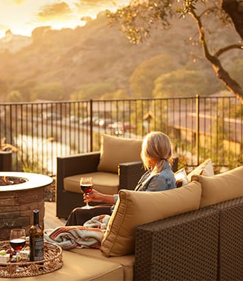 A woman lounging at the Treehouse patio